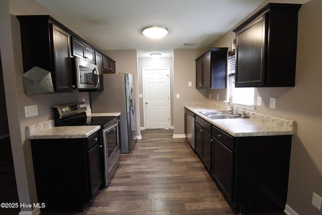 205 S Creek Dr, Jacksonville, NC 28540 - kitchen with appliances with stainless steel finishes, a sink, dark wood-style flooring, and light countertops