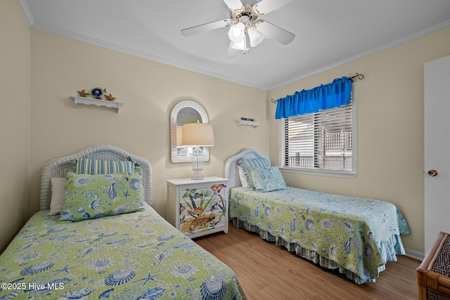 bedroom with ornamental molding, wood finished floors, and ceiling fan