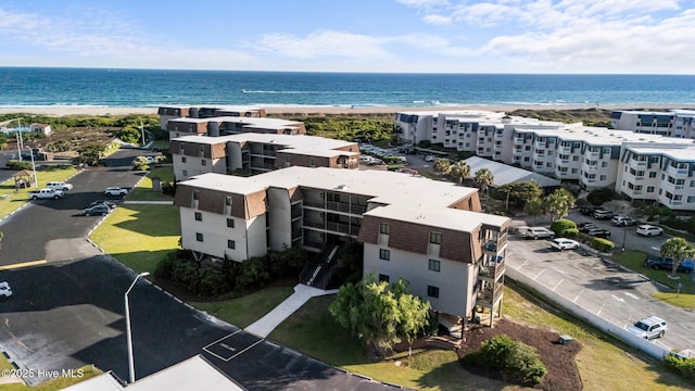 drone / aerial view of a large body of water and apartment complex / building