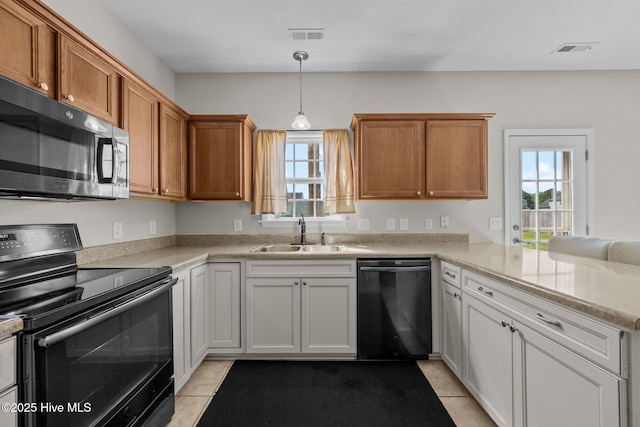 kitchen featuring a sink, dishwashing machine, range with electric cooktop, and a healthy amount of sunlight