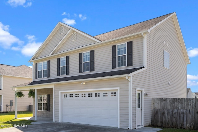view of front of home with concrete driveway, an attached garage, and fence