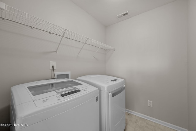 clothes washing area featuring laundry area, baseboards, washer and dryer, and visible vents