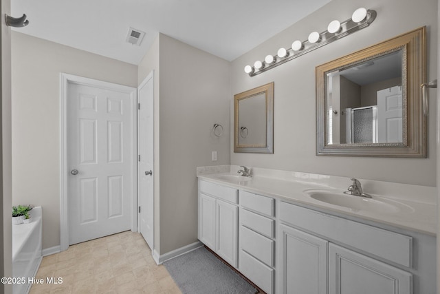 bathroom with a sink, baseboards, double vanity, and visible vents