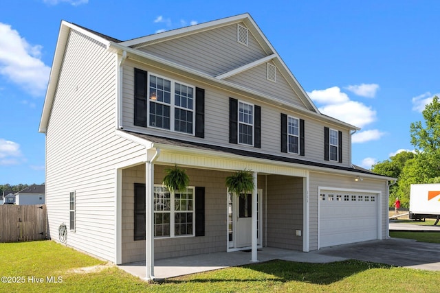 traditional home with concrete driveway, an attached garage, fence, and covered porch