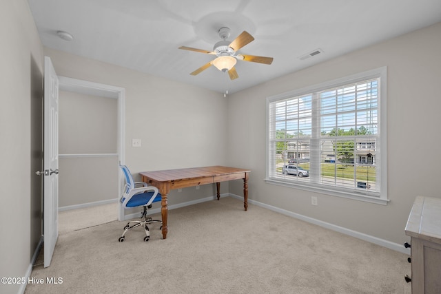 office featuring carpet flooring, a ceiling fan, baseboards, and visible vents