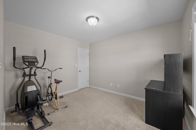 workout room with baseboards and carpet flooring
