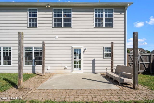 rear view of house featuring a patio area and fence