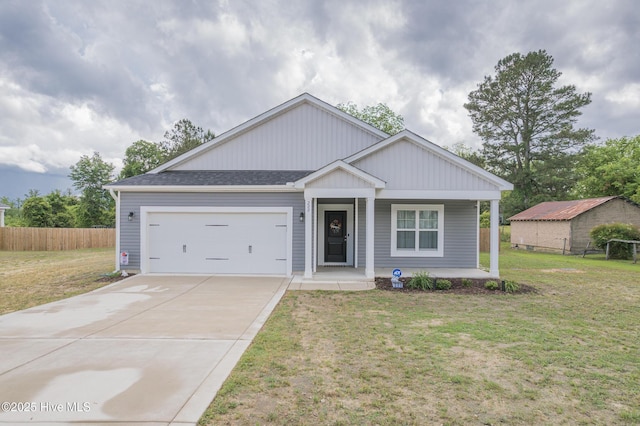 200 Laurel Lake Rd, Salemburg, NC 28385 - view of front of property with a porch, driveway, fence, and a front yard