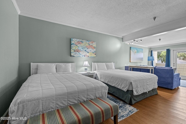 602 W Fort Macon Rd Unit 135, Atlantic Beach, NC 28512 - bedroom featuring a textured ceiling, crown molding, rail lighting, wood finished floors, and access to outside