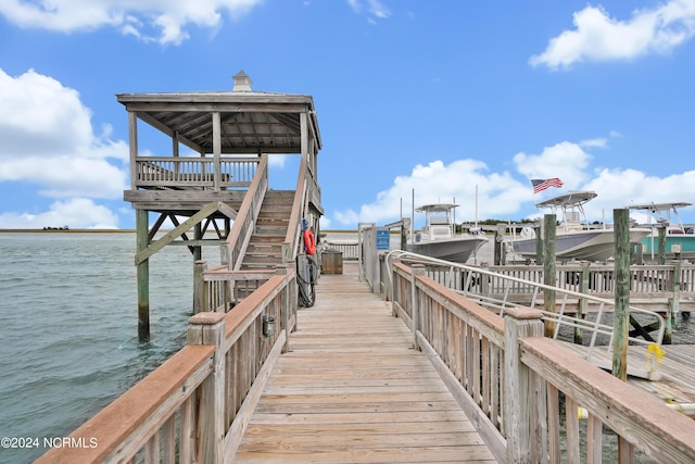 view of dock featuring boat lift and a water view