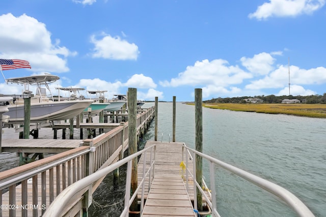 view of dock with boat lift and a water view