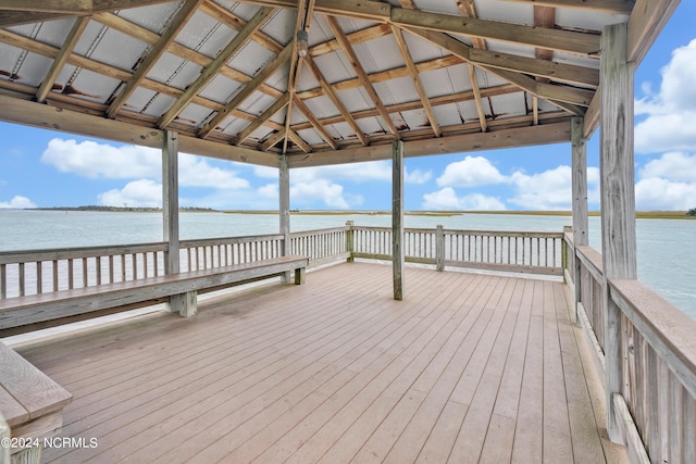 view of dock with a gazebo and a deck with water view