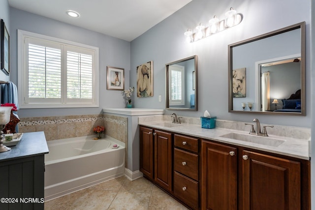 bathroom with a sink, a bath, tile patterned flooring, and double vanity