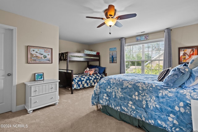 bedroom featuring ceiling fan, carpet, and visible vents