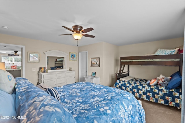 bedroom with a ceiling fan and carpet