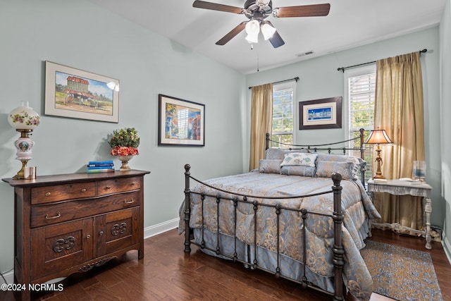 bedroom with baseboards, ceiling fan, dark wood-style flooring, and visible vents