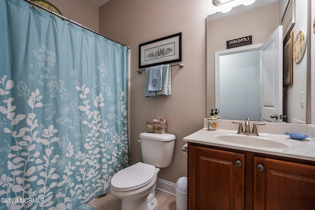 full bathroom featuring vanity, tile patterned floors, baseboards, toilet, and a shower with shower curtain