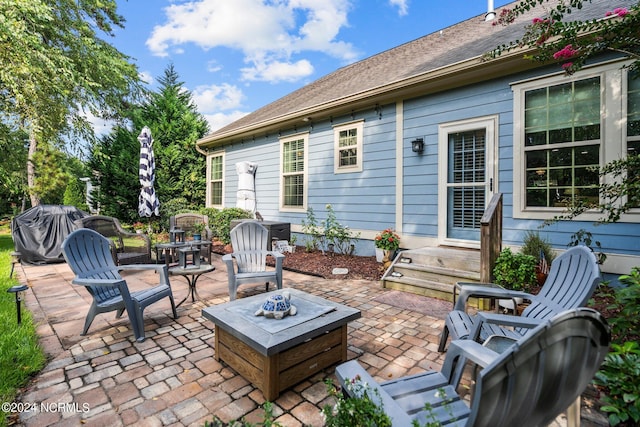 view of patio / terrace with area for grilling and an outdoor fire pit