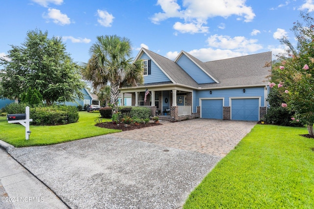 view of front of home featuring a porch, a garage, decorative driveway, brick siding, and a front lawn