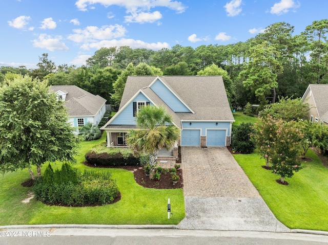 view of front of house featuring brick siding, a front lawn, and driveway