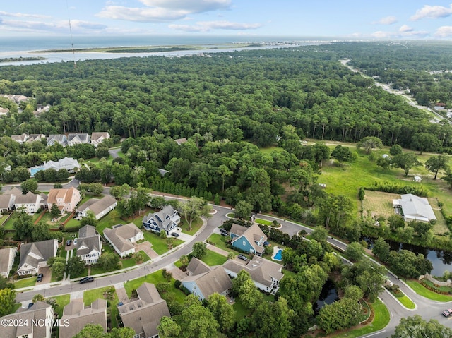 aerial view with a water view, a view of trees, and a residential view
