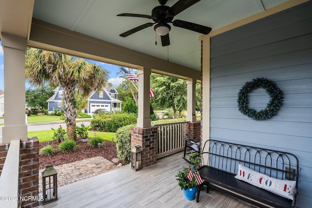 wooden terrace featuring a ceiling fan and covered porch