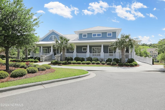 view of front of house featuring a porch and metal roof