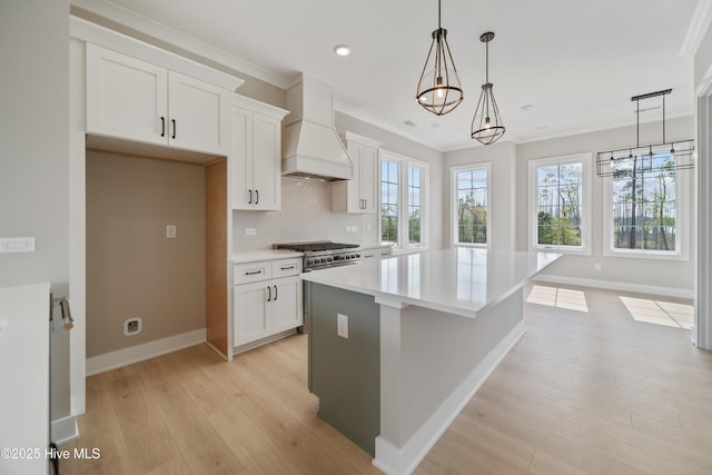 2652 Alvernia Dr, Castle Hayne, NC 28429 - kitchen with custom range hood, a chandelier, baseboards, a kitchen island, and recessed lighting