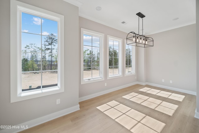 2652 Alvernia Dr, Castle Hayne, NC 28429 - unfurnished dining area with a chandelier, ornamental molding, light wood-type flooring, and baseboards