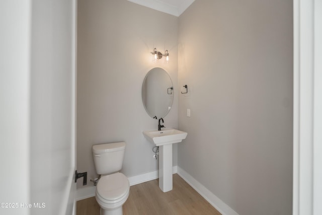 2652 Alvernia Dr, Castle Hayne, NC 28429 - bathroom with wood finished floors, toilet, and baseboards