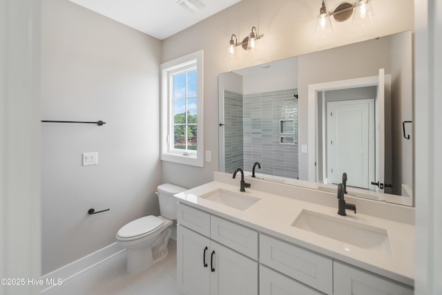 2652 Alvernia Dr, Castle Hayne, NC 28429 - full bathroom featuring baseboards, double vanity, toilet, a tile shower, and tile patterned floors
