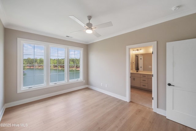 2652 Alvernia Dr, Castle Hayne, NC 28429 - unfurnished bedroom with light wood finished floors, baseboards, crown molding, connected bathroom, and a ceiling fan