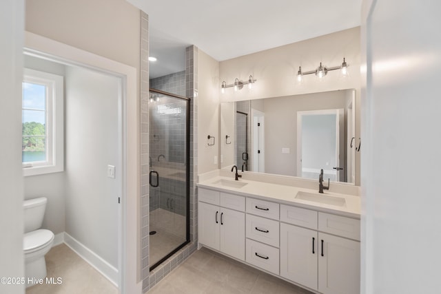 2652 Alvernia Dr, Castle Hayne, NC 28429 - bathroom featuring double vanity, a shower stall, toilet, and tile patterned floors