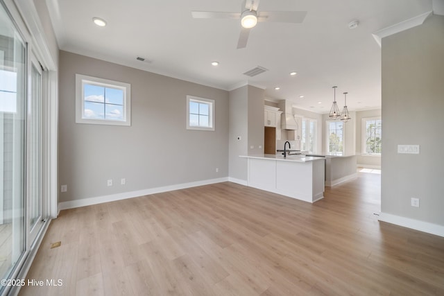 2652 Alvernia Dr, Castle Hayne, NC 28429 - unfurnished living room with light wood-style floors, baseboards, a ceiling fan, recessed lighting, and a chandelier