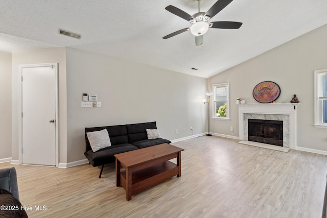 2686 Idlebrook Cir, Midway Park, NC 28544 - living room with a ceiling fan, light wood finished floors, a premium fireplace, baseboards, and lofted ceiling