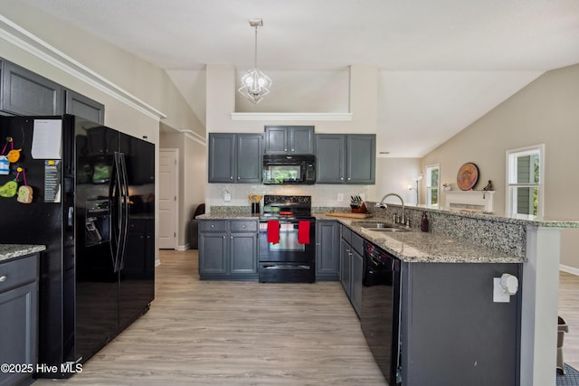 2686 Idlebrook Cir, Midway Park, NC 28544 - kitchen with black appliances, a sink, a peninsula, light wood-style floors, and light stone countertops