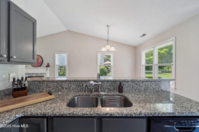 2686 Idlebrook Cir, Midway Park, NC 28544 - kitchen with black dishwasher, a sink, dark stone counters, vaulted ceiling, and pendant lighting