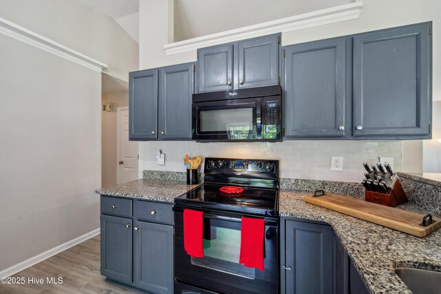 2686 Idlebrook Cir, Midway Park, NC 28544 - kitchen with black appliances, decorative backsplash, light wood-style flooring, light stone counters, and baseboards