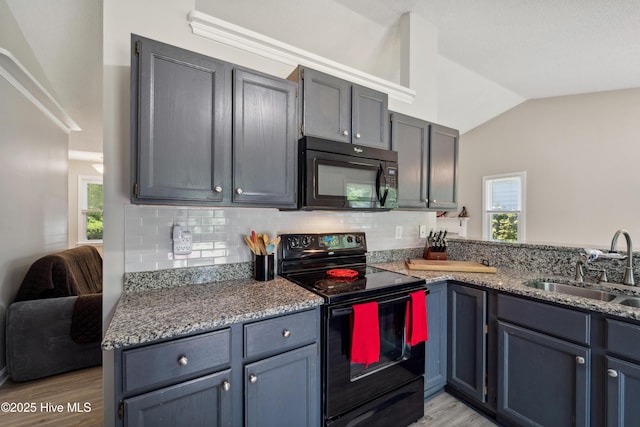 2686 Idlebrook Cir, Midway Park, NC 28544 - kitchen featuring black appliances, a sink, backsplash, light wood-style floors, and lofted ceiling