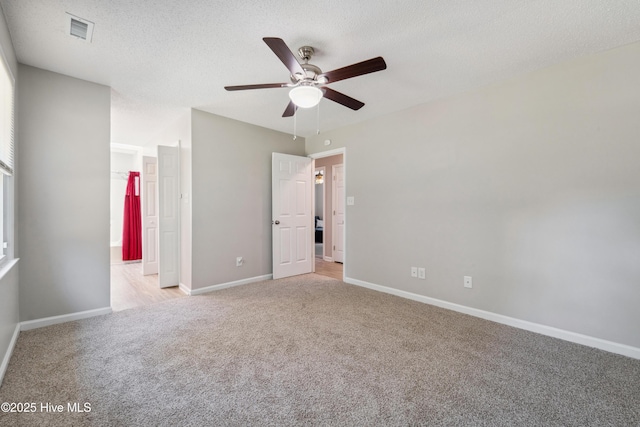 2686 Idlebrook Cir, Midway Park, NC 28544 - unfurnished bedroom featuring light colored carpet, baseboards, a textured ceiling, ceiling fan, and ensuite bath