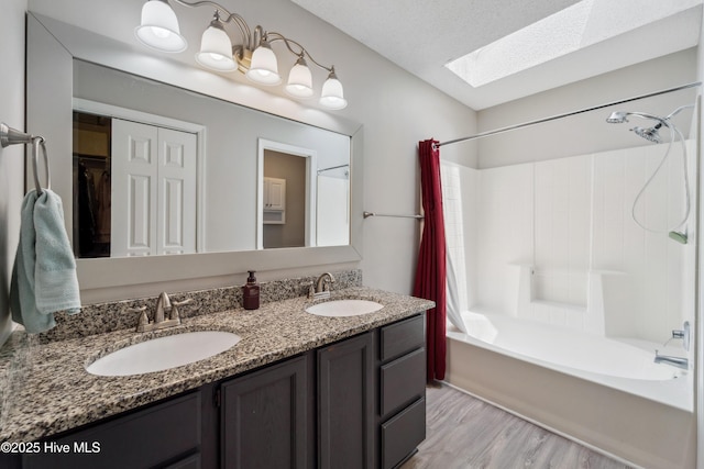 2686 Idlebrook Cir, Midway Park, NC 28544 - bathroom featuring shower / bath combo, a skylight, double vanity, wood finished floors, and a closet