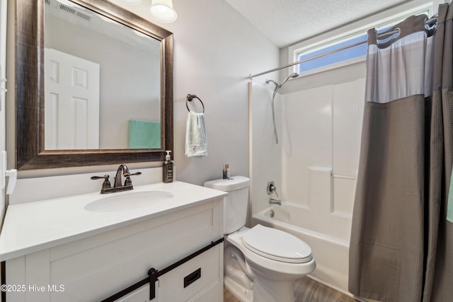 2686 Idlebrook Cir, Midway Park, NC 28544 - full bathroom featuring shower / bath combo, vanity, toilet, a textured ceiling, and wood finished floors