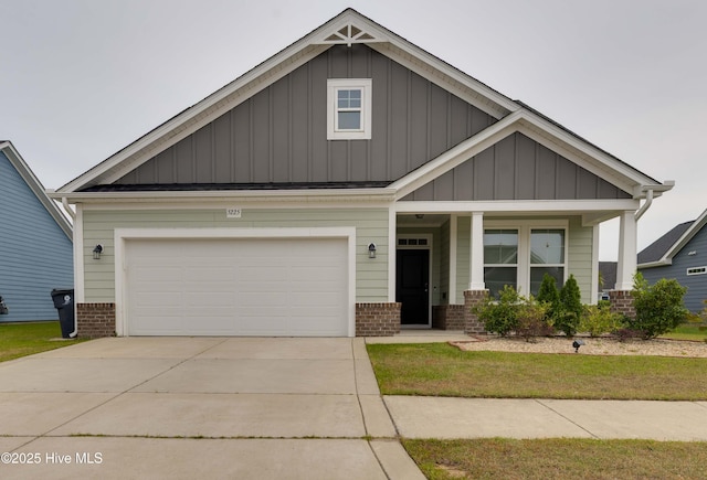 craftsman house featuring a garage, board and batten siding, driveway, and brick siding