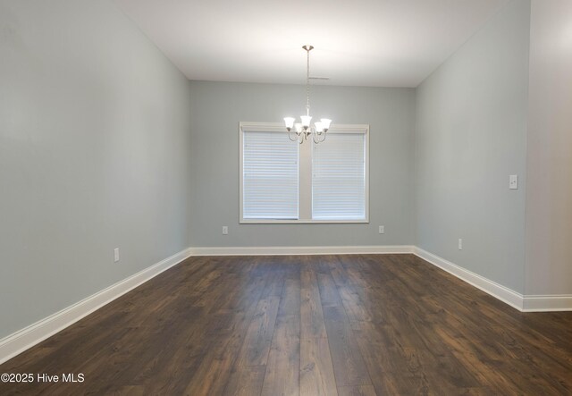 5225 National Garden Trl, Winnabow, NC 28479 - spare room featuring baseboards, a chandelier, and dark wood finished floors
