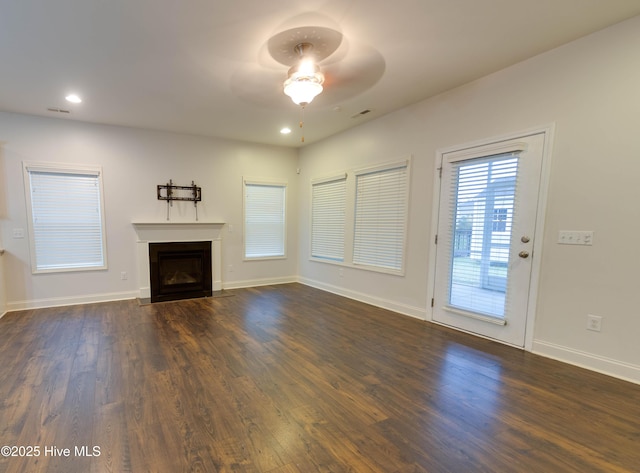 5225 National Garden Trl, Winnabow, NC 28479 - unfurnished living room featuring a fireplace with flush hearth, ceiling fan, recessed lighting, and dark wood-type flooring