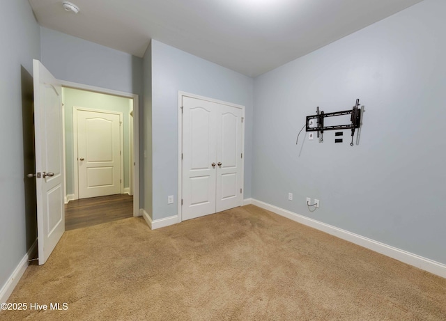 5225 National Garden Trl, Winnabow, NC 28479 - unfurnished bedroom with carpet floors, baseboards, and a closet