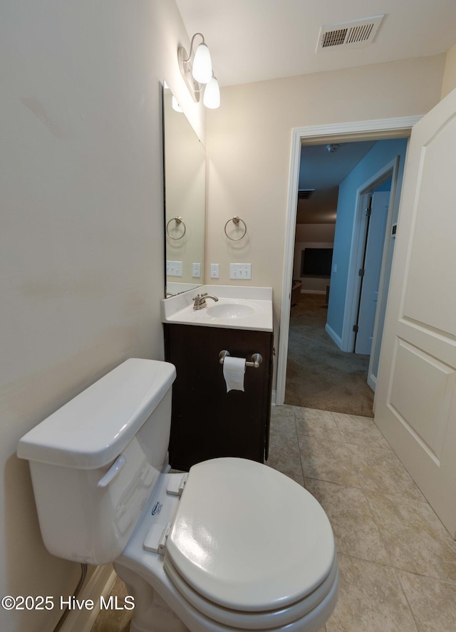 5225 National Garden Trl, Winnabow, NC 28479 - half bathroom with vanity, tile patterned floors, toilet, and visible vents