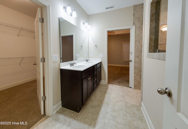 5225 National Garden Trl, Winnabow, NC 28479 - full bath with visible vents, tile patterned flooring, double vanity, a walk in closet, and a sink