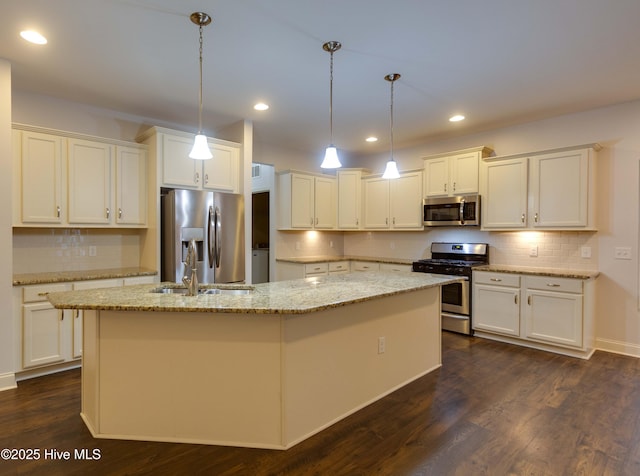 5225 National Garden Trl, Winnabow, NC 28479 - kitchen featuring appliances with stainless steel finishes, backsplash, dark wood-style floors, and an island with sink