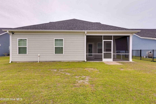5225 National Garden Trl, Winnabow, NC 28479 - back of house featuring a lawn, fence, a shingled roof, and a sunroom